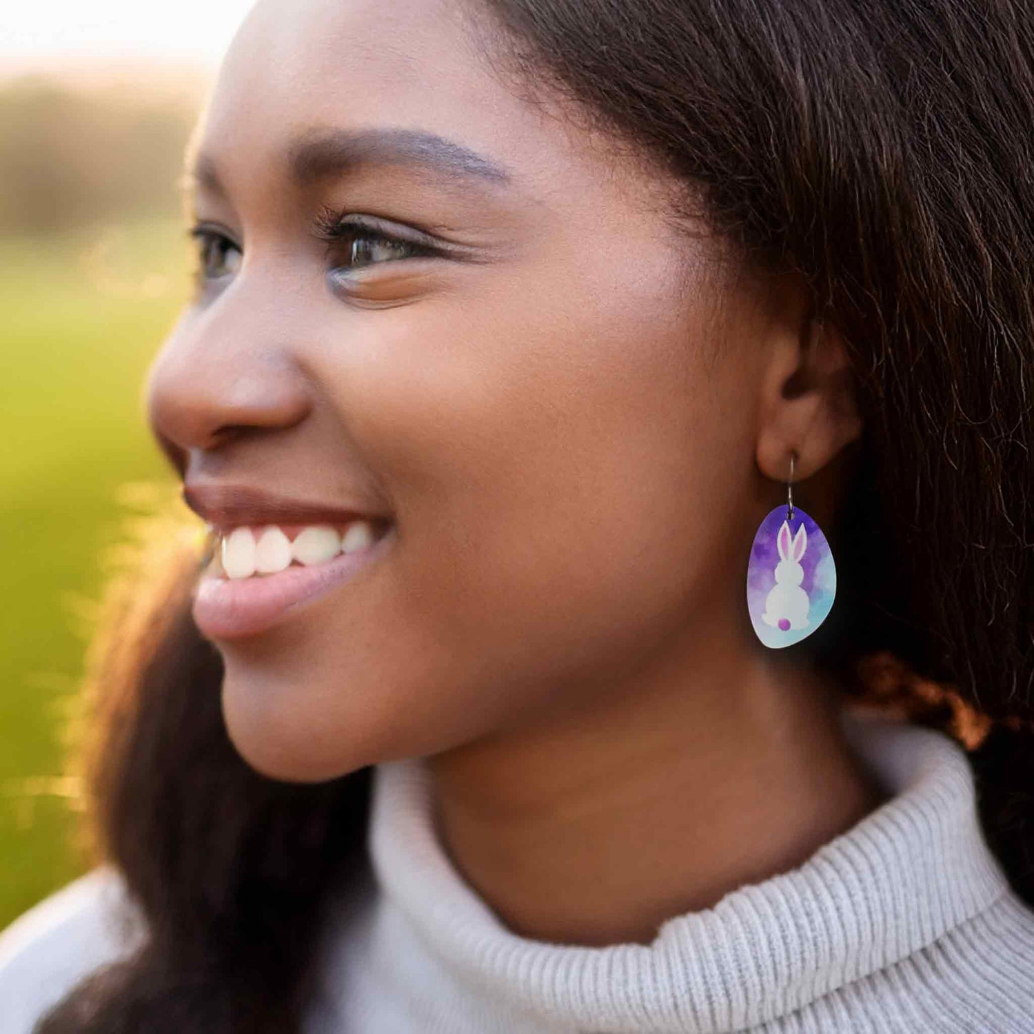 Model wearing purple easter bunny dangle earrings by ColorUpLife.