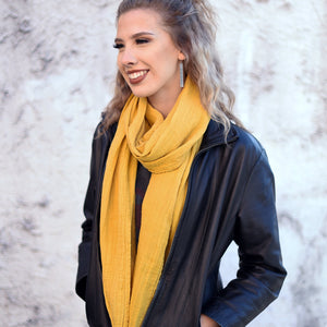 Young lady wearing a light mustard cotton double gauze scarf by ColorUpLife