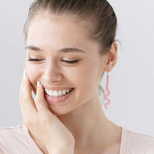 Woman wearing caddy pink zig zag earrings by ColorUpLife.