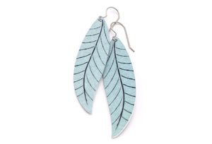 A pair of long gray leaf earrings by ColorUpLife.