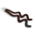 A pair of wavy, black dangle earrings made of aluminum with silver-tone titanium ear wires, shown on a plain white background.