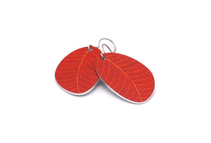 A pair of small leaf earrings in burnt red by ColorUpLife.