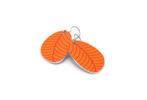 A pair of small leaf earrings in orange by ColorUpLife.