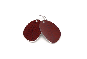 A pair of small leaf earrings in rustic red by ColorUpLife.