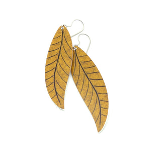 A pair of long brown leaf earrings by ColorUpLife.