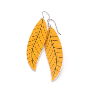 A pair of long golden yellow leaf earrings by ColorUpLife.