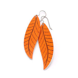 A pair of long orange leaf earrings by ColorUpLife.
