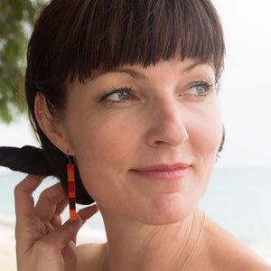 Woman wearing warm tone color block bar earrings by ColorUpLife.