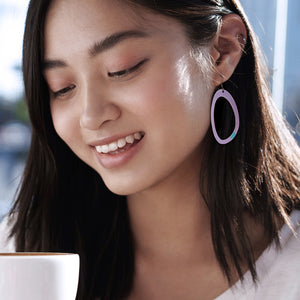 Young lady wearing light purple hoop earrings by ColorUpLife